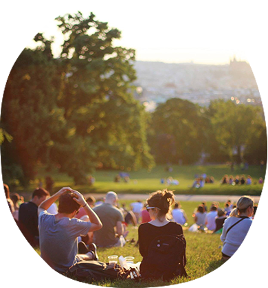 a group of people sitting on grass