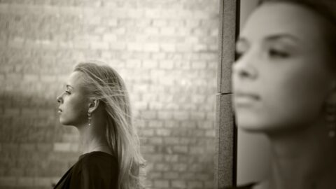 a woman with long hair and a black shirt after IPT, interpersonal therapy session at REACH