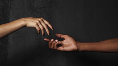 A hand reaching out to another hand, symbolizing the effort to overcome relationship difficulties and reconnect through better communication. REACH Behavioral Health, Ohio