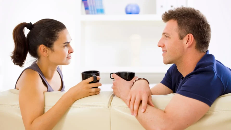 Couple having a quiet conversation at home, symbolizing emotional connection and support before their first couples therapy session.